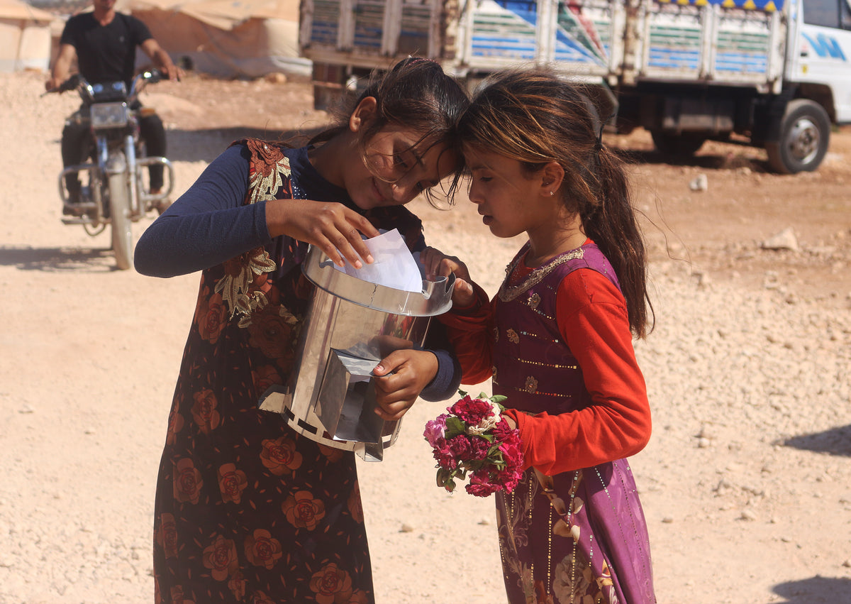 Two young girls holding a "fire for life"